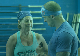Dustin and Melita talking over technique and form in workout gear