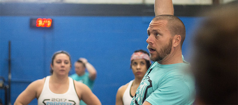 Warren teaching dumbbell snatch technique in specialty classes